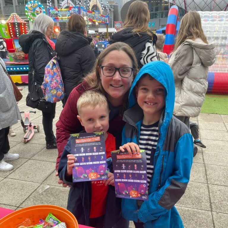 a photo of a family enjoying arc's spooktacular halloween event