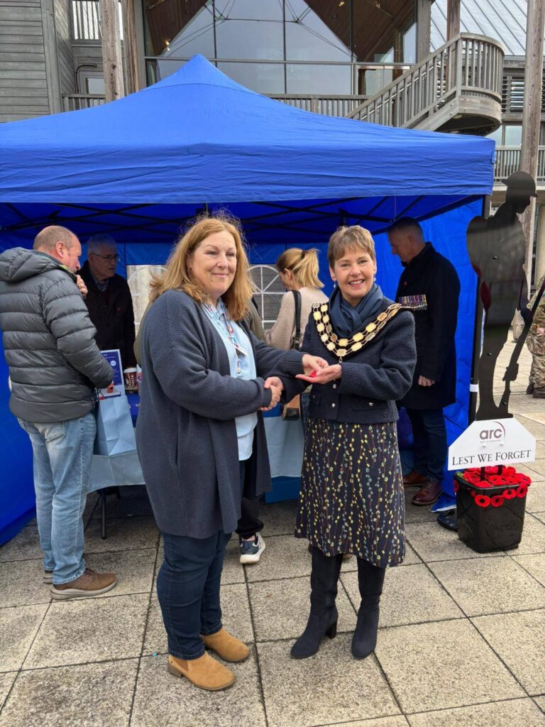 Bury St Edmunds mayor, Councillor Donna Higgins, accepting the first poppy of the 2025 appeal from a RBL volunteer last year.